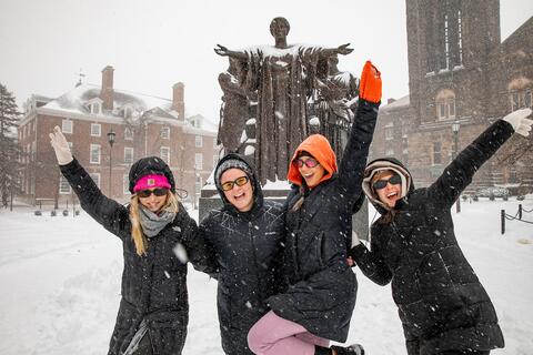 Students playing in the snow in front of Alma